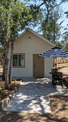 a house with a picnic table and an umbrella at Clingan's Junction Cottage #4 in Squaw Valley