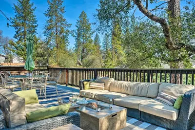 a patio with a couch and tables on a deck at Groveland Cabin with Outdoor Perks and Game Room in Groveland