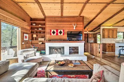 a living room with a couch and a fireplace at Groveland Cabin with Outdoor Perks and Game Room in Groveland