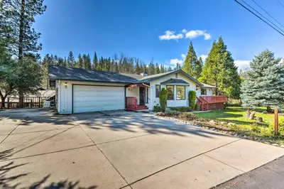 a house with a garage and a driveway at Deck and Hot Tub Rustic Groveland Home! in Groveland