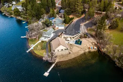 an aerial view of a house on an island in the water at Deck and Hot Tub Rustic Groveland Home! in Groveland