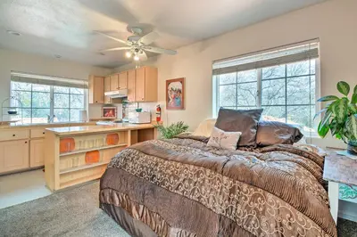a large bedroom with a bed and a kitchen at Romantic Treetop Studio 30 Mi to Yosemite! in Coarsegold