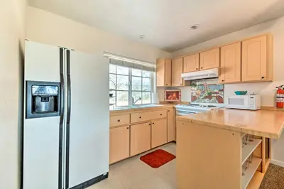 a kitchen with a white refrigerator and a counter at Romantic Treetop Studio 30 Mi to Yosemite! in Coarsegold