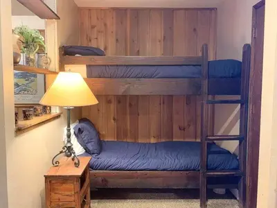 a room with two bunk beds and a lamp at 1 Bedroom Standard Condos in Mammoth Lakes