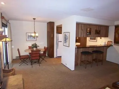 a living room and kitchen with a table and chairs at 1 Bedroom Standard Condos in Mammoth Lakes