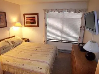 a hotel room with a bed and a window at 1 Bedroom Premium Condos in Mammoth Lakes