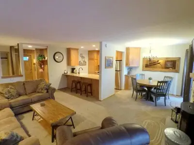 a living room and kitchen with a couch and a table at 1 Bedroom Premium Condos in Mammoth Lakes