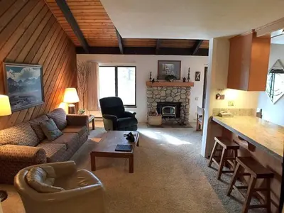 a living room with a couch and a fireplace at Standard Condos with Free Parking in Mammoth Lakes