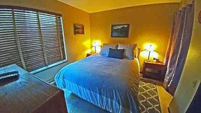 a bedroom with a large bed and two lamps at Standard Condos with Free Parking in Mammoth Lakes