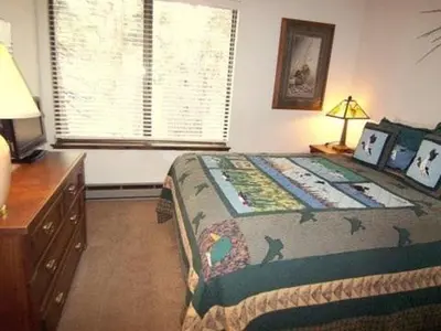a bedroom with a bed and a dresser and a window at Standard Condos with Free Parking in Mammoth Lakes
