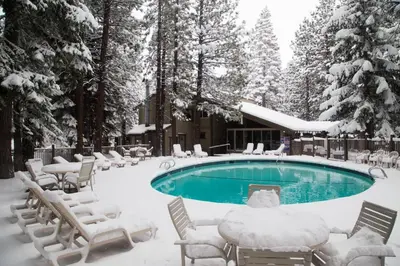 a swimming pool covered in snow next to a resort at 2 Bedrooms Premium Condos in Mammoth Lakes