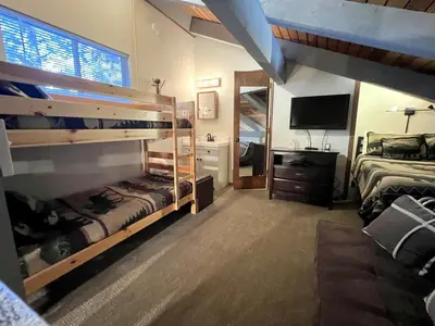 a bedroom with two bunk beds and a television at 2 Bedrooms Standard Condos in Mammoth Lakes