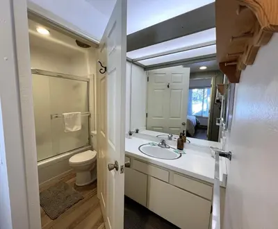 a bathroom with a sink and a toilet and a mirror at 2 Bedrooms Standard Condos in Mammoth Lakes