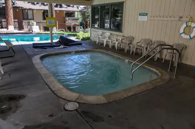 a large swimming pool with chairs and a table at Discover 4 in Mammoth Lakes