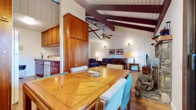 a kitchen and dining room with a wooden table at Discover 4 in Mammoth Lakes