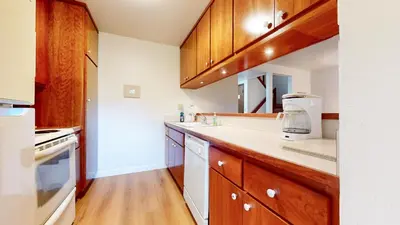 a kitchen with wooden cabinets and white appliances at Discover 4 in Mammoth Lakes