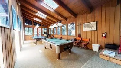 a room with a pool table in a house at Mammoth Estates Condo - Free Parking & Pet Friendly in Mammoth Lakes