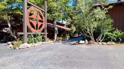 a building with a sign on the side of a road at Mammoth Estates Condo - Free Parking & Pet Friendly in Mammoth Lakes