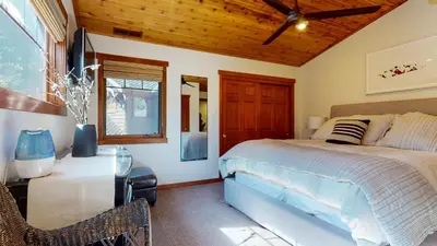 a bedroom with a bed and a desk and a window at Grayfox 2 Pet-Friendly, 5-Star with Private Hot Tub, 2 Car Garage and Prime Location condo in Mammoth Lakes