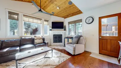 a living room with a leather couch and a fireplace at Grayfox 2 Pet-Friendly, 5-Star with Private Hot Tub, 2 Car Garage and Prime Location condo in Mammoth Lakes