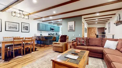 a living room with a couch and a table at Val DIsere 32 Pet-Friendly, Walk To The Village, Private Washer Dryer, Spacious Floorplan condo in Mammoth Lakes