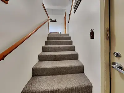 a staircase in a house with a gray carpet at Summer Fun - SLOPESIDE 4BR 3BA with 3 Spas, Pool and Sauna - Perfect for Family and Friend Getaways All Year Round 1849 Condos 693 condo in Mammoth Lakes
