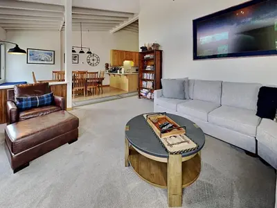 a living room with a couch and a table at Summer Fun - SLOPESIDE 4BR 3BA with 3 Spas, Pool and Sauna - Perfect for Family and Friend Getaways All Year Round 1849 Condos 693 condo in Mammoth Lakes