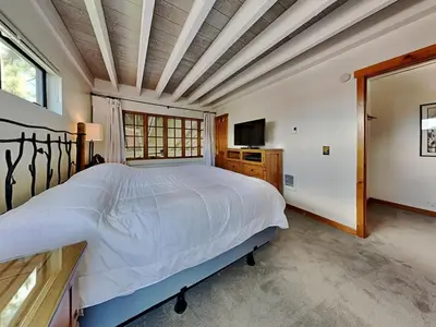 a bedroom with a large bed and a television at Summer Fun - SLOPESIDE 4BR 3BA with 3 Spas, Pool and Sauna - Perfect for Family and Friend Getaways All Year Round 1849 Condos 693 condo in Mammoth Lakes