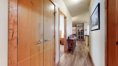 a hallway with wooden cabinets and a desk in a room at Solstice 11 Amazing Location on Golf Course, Heated Garage, Private Washer Dryer condo in Mammoth Lakes