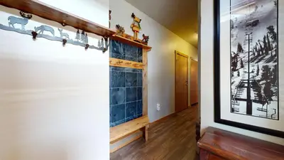a hallway with a wall with blue tile at Solstice 11 Amazing Location on Golf Course, Heated Garage, Private Washer Dryer condo in Mammoth Lakes