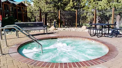 a hot tub with snow inside of it with a bench at Solstice 11 Amazing Location on Golf Course, Heated Garage, Private Washer Dryer condo in Mammoth Lakes