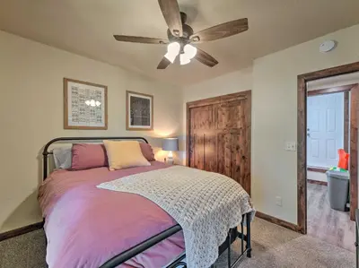 a bedroom with a bed and a ceiling fan at Woodsy Retreat Modern Mi-Wuk Village Cabin! in Mi-Wuk Village