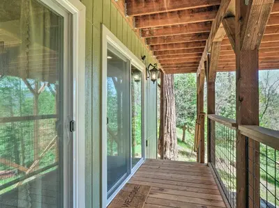 an empty porch of a house with a wooden walkway at Woodsy Retreat Modern Mi-Wuk Village Cabin! in Mi-Wuk Village