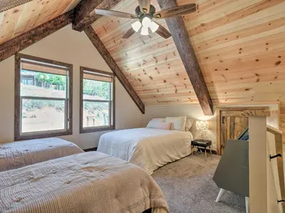 a bedroom with two beds and a ceiling fan at Woodsy Retreat Modern Mi-Wuk Village Cabin! in Mi-Wuk Village