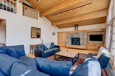 a living room with blue furniture and a fireplace at Mountain & Lake-View Delight in Truckee