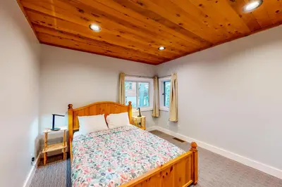 a bedroom with a bed and a wooden ceiling at Mountain & Lake-View Delight in Truckee