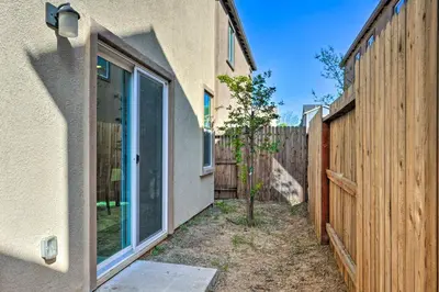 a building with a window next to a fence at Modern Sacramento House about 12 Mi to Downtown! in Sacramento