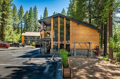 a cabin in the woods with a parking lot at The Incline Lodge in Incline Village