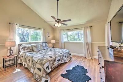 a bedroom with a bed and a ceiling fan at Luxury Auberry Retreat in Sierra National Forest in Auberry