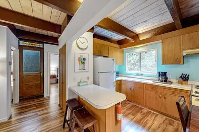a kitchen with wooden cabinets and a white refrigerator at Hidden Haven in Arnold