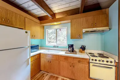 a kitchen with wooden cabinets and a white refrigerator at Hidden Haven in Arnold