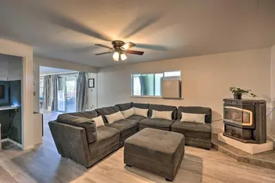 a living room with a couch and a ceiling fan at Jackson Escape with Hot Tub and Mtn Views! in Jackson