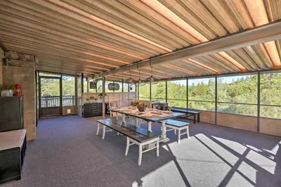 a large room with a table and some windows at Jackson Escape with Hot Tub and Mtn Views! in Jackson