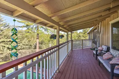 a porch with a couch and chairs on it at Jackson Escape with Hot Tub and Mtn Views! in Jackson