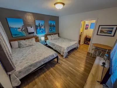 a bedroom with two beds and a table and chairs at The Chalet at Kings Beach Unit 1 in Kings Beach