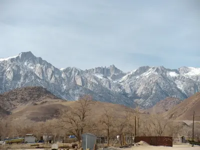 a mountain range with snow covered mountains in the distance at Lone Pine Budget Inn in Lone Pine