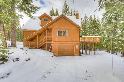 a log cabin in the woods in the snow at Bolzano's Getaway in Truckee