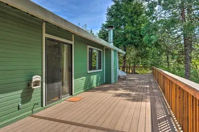 a green house with a wooden deck on the side of it at 10 Acres with Stunning Views Apple Hill Home! in Camino