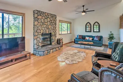 a living room with a fireplace and a tv at 10 Acres with Stunning Views Apple Hill Home! in Camino