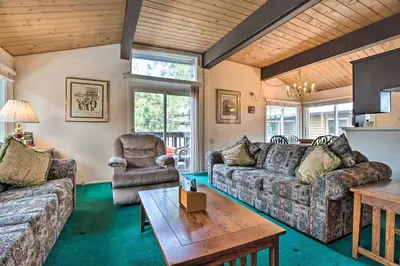 a living room with couches and a table at Mammoth Lakes Townhome Less Than 2 Mi to Ski Area! in Mammoth Lakes